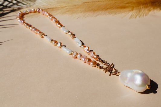 Hera Necklace in Pink Baroque Pearls with a Striking Fireball Pearl Pendant, adorned with a Gold-Filled Toggle Clasp. A regal 16-inch piece from 'Hera Jewels,' symbolizing the strength and commitment of the Hera archetype in divine feminine adornment.
